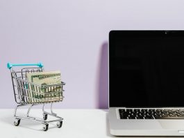 shopping cart next to a laptop