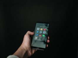 photo of hand holding a black smartphone