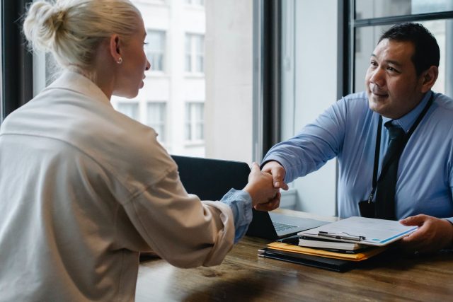 Develop soft skills ethnic businessman shaking hand of applicant in office