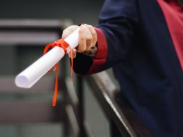 person holding white scroll