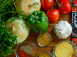 assorted vegetables and spices on wood surface