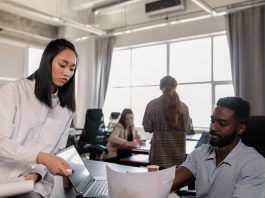 woman in white long sleeve shirt sitting beside man in gray shirt